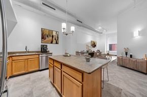 Detroit apartment for rent - A kitchen with wooden cabinets and a marble countertop.