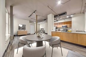 Detroit apartment for rent - A modern dining room with a round table and chairs.