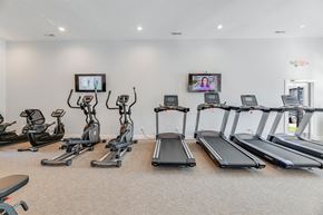 Columbus apartment for rent - A gym with treadmills, exercise bikes, and elliptical machines.