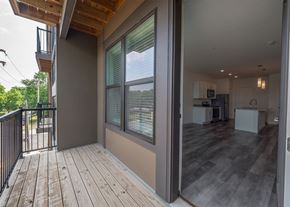 Columbus apartment for rent - A balcony with a view of trees and a house.