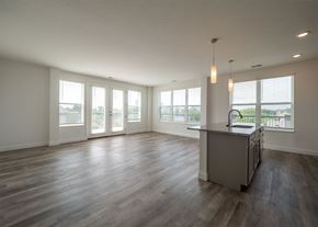 Columbus apartment for rent - A spacious room with a bar and wooden floors.