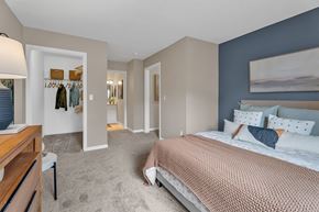 Southgate apartment for rent - A bedroom with a large bed and a wooden dresser.