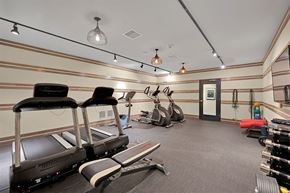 Highland Park apartment for rent - a gym with various machines and chairs in it