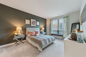 Aurora apartment for rent - A bedroom with a large bed and a window with curtains.