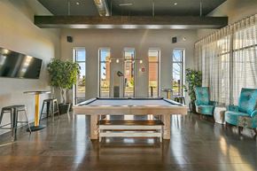 Aurora apartment for rent - A room with a pool table and a bar area.