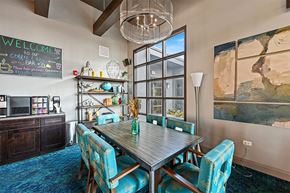 Aurora apartment for rent - A dining room with a wooden table and blue chairs.