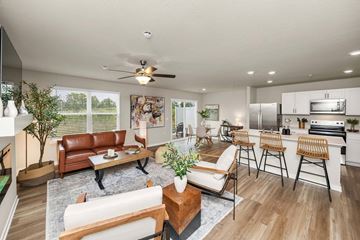 Urbandale apartment for rent - A modern living room with a brown leather couch and a wooden coffee table.