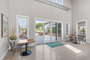Victoria apartment for rent - A dining room with a table and chairs and a view of the backyard through the glass doors.