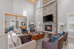 Victoria apartment for rent - A living room with a stone fireplace and a large couch.