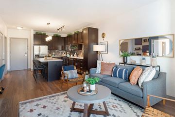 St. Louis Park apartment for rent - a living room and kitchen with a couch and a table