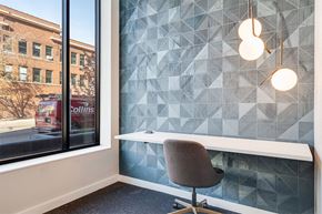 Saint Paul apartment for rent - A chair is in front of a window with a view of a building with the sign "Collins".