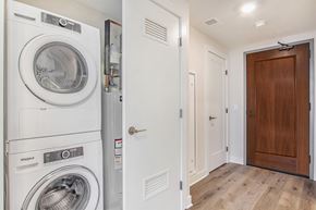 Battle Creek apartment for rent - A white Whirlpool washing machine and dryer in a small laundry room.