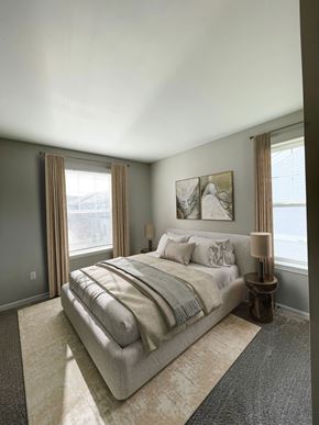 Royal Oak apartment for rent - A bedroom with a large bed and a window with curtains.