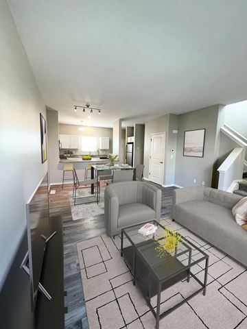 Royal Oak apartment for rent - A modern living room with a glass coffee table and a grey couch.