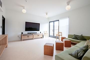 Pittsburgh apartment for rent - A living room with a green couch and a television.