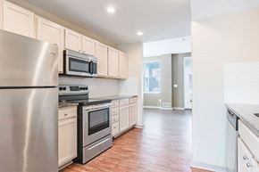Columbus apartment for rent - A kitchen with a stainless steel refrigerator, microwave, oven, and dishwasher.