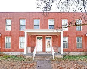 Columbus apartment for rent - A red brick building with a white door and windows.
