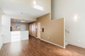 Columbus apartment for rent - A spacious room with wooden floors and white walls.