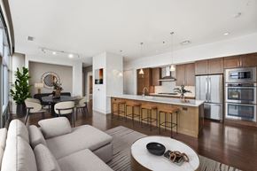 Cleveland apartment for rent - A modern open plan living and kitchen area with a bar stool.