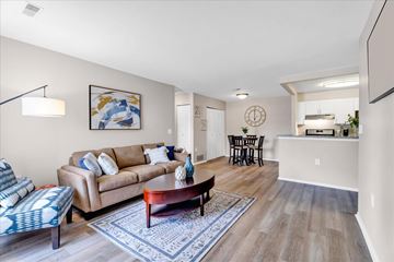 Orion Charter Twp apartment for rent - A living room with a couch, a coffee table, and a painting on the wall.