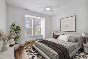 Detroit apartment for rent - A bedroom with a large bed and a ceiling fan.