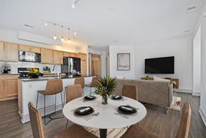 Detroit apartment for rent - A modern dining room with a white table set for four.