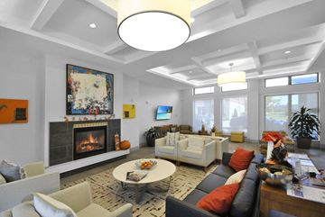 Detroit apartment for rent - A living room with a fireplace and a painting on the wall.