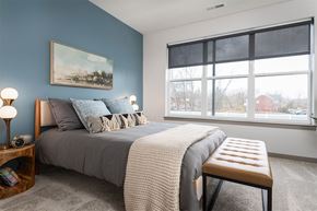 Cincinnati apartment for rent - a bedroom with a bed and a large window