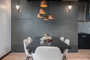 Cincinnati apartment for rent - a dining room with a black table and white chairs