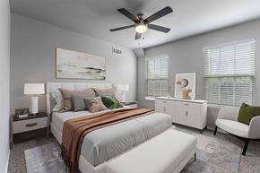 Rogers apartment for rent - A bedroom with a large bed and a ceiling fan.