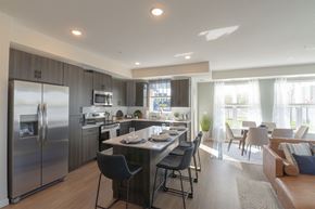 Chaska apartment for rent - a kitchen and dining room with stainless steel appliances and a table and chairs