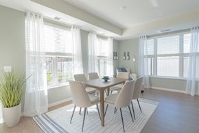 Chaska apartment for rent - a dining room with a table and chairs and windows