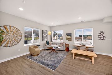 West Des Moines apartment for rent - A living room with a large rug and a wooden bench.