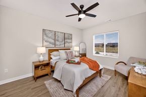 West Des Moines apartment for rent - A bedroom with a bed, nightstand, and chair.