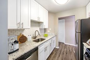 Schaumburg apartment for rent - a kitchen with white cabinets and a stainless steel refrigerator