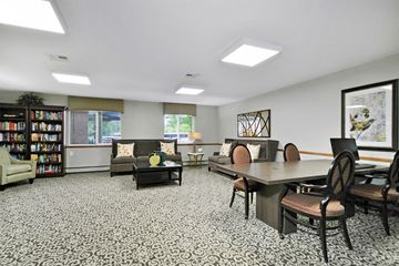 Livonia apartment for rent - a living room with a table and chairs and a library