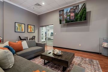 Pikeville apartment for rent - A living room with a grey couch, a coffee table, and a painting on the wall.