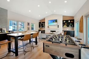 Kalamazoo apartment for rent - a game room with a foosball table and a bar