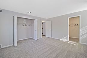 Kalamazoo apartment for rent - an empty bedroom with mirrored closet doors and carpeting