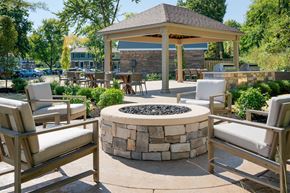 Amelia townhouse for rent - a fire pit with chairs and a gazebo in the middle of a