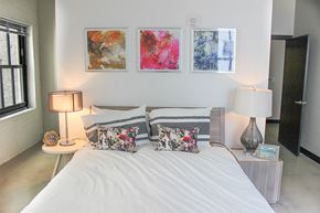 St. Paul apartment for rent - A bedroom with a large bed and two lamps.