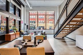 St. Paul apartment for rent - A modern dining room with a long table and chairs.