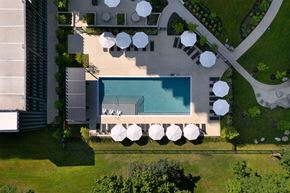 Shaker Heights apartment for rent - A pool surrounded by white umbrellas and a building.