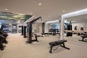 Shaker Heights apartment for rent - A gym with a variety of equipment including a rowing machine, bench, and weights.