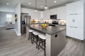 Cincinnati apartment for rent - A modern kitchen with a large island and stainless steel appliances.