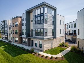 Cincinnati apartment for rent - A modern apartment complex with a mix of brick and stone exteriors.