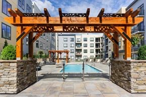 Cincinnati apartment for rent - A wooden pergola over a pool in a residential area.
