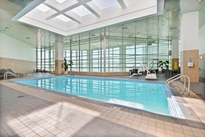 Detroit apartment for rent - A large indoor swimming pool with sunlight streaming in through the windows.