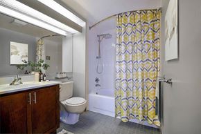 Detroit apartment for rent - A bathroom with a toilet, sink, and shower.