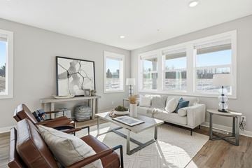 Lakeville apartment for rent - A living room with a brown leather chair and a glass coffee table.